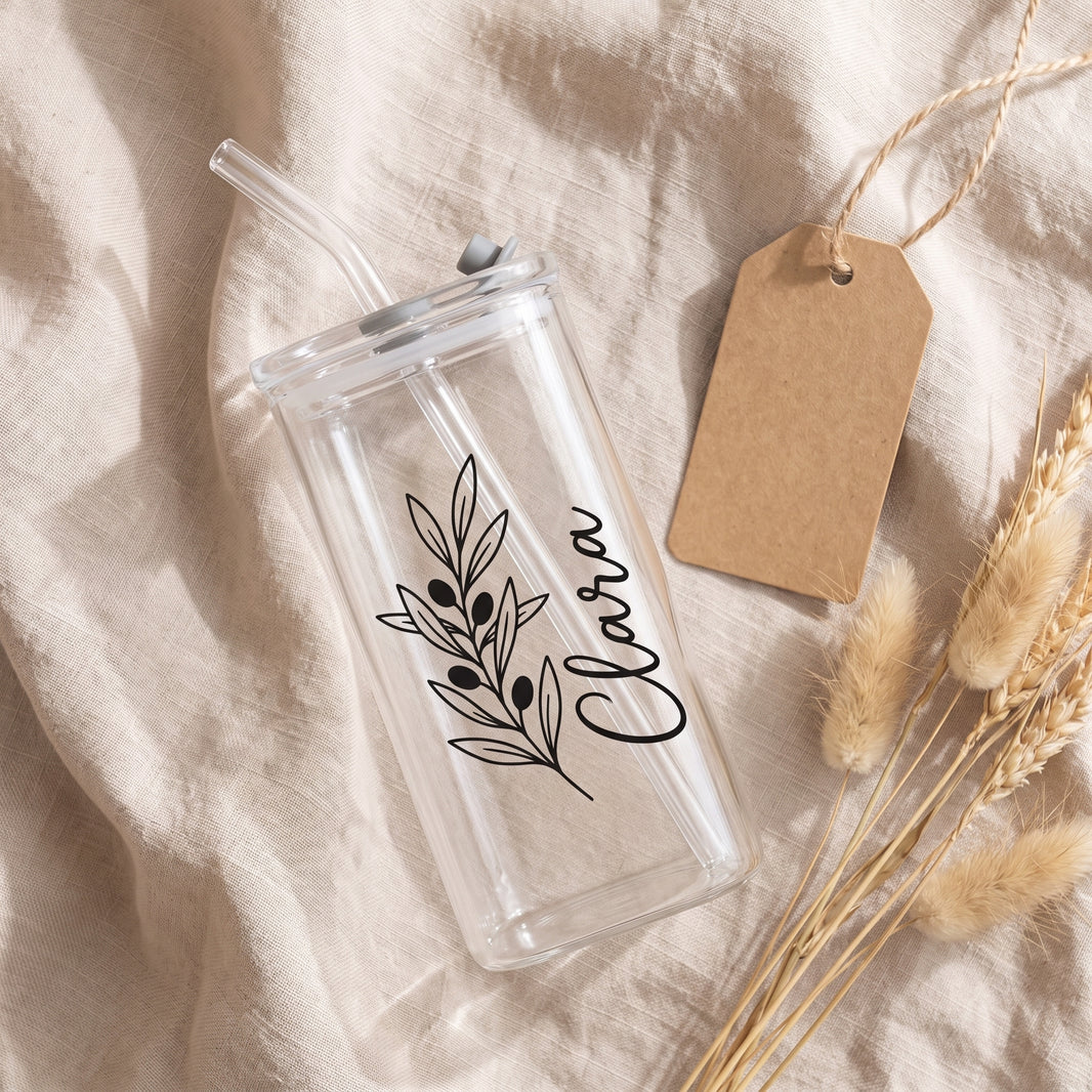 Personalised glass styled as a gift with kraft tag and dried grasses on linen
