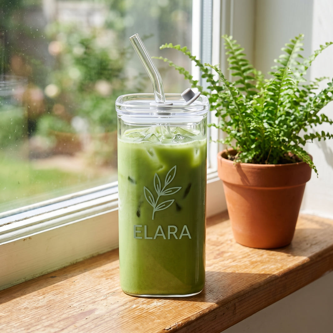 Custom name cup filled with iced matcha on a sunny kitchen windowsill
