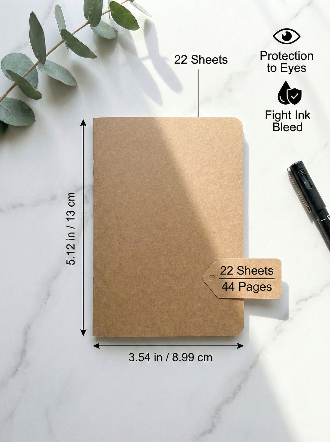 Brown notebook with measurements and features on a white marble surface