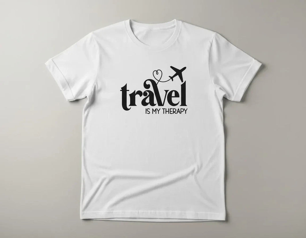White t-shirt with 'Travel is my Therapy' text on a gray background