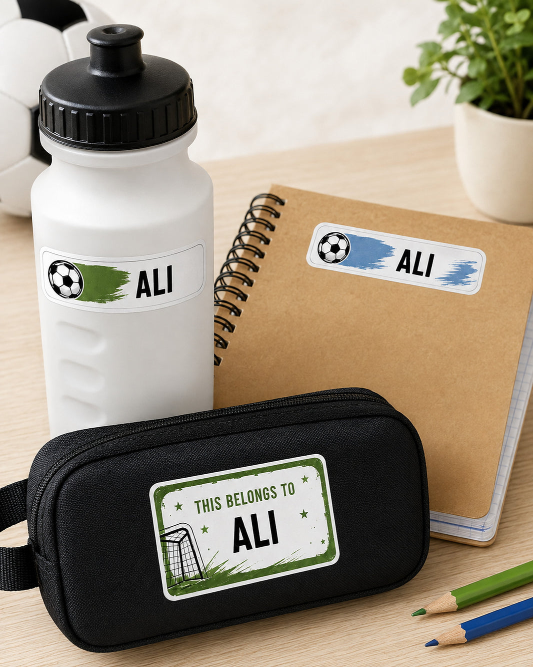 Football Star name labels applied to a white sports bottle, notebook and black pencil case