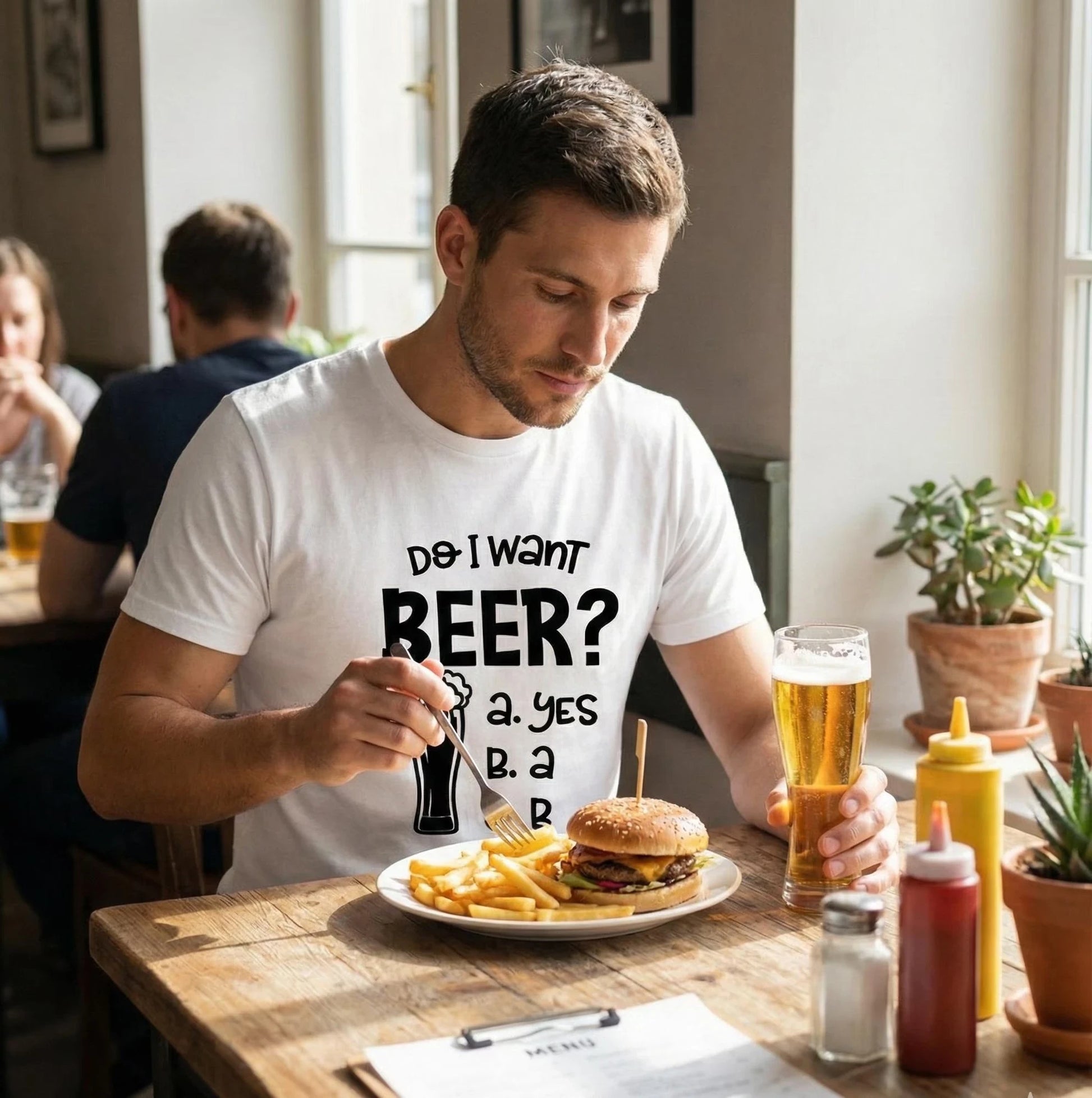 Man sitting at a table with a burger, fries, and beer in a casual setting