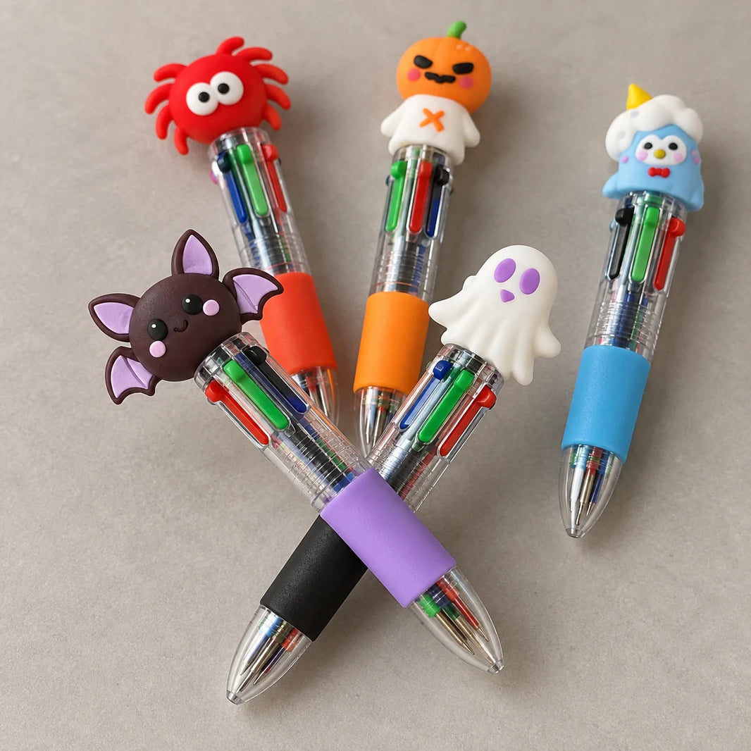Close-up of the four retractable black, blue, red and green colour selector buttons on five Halloween character ballpoint pens