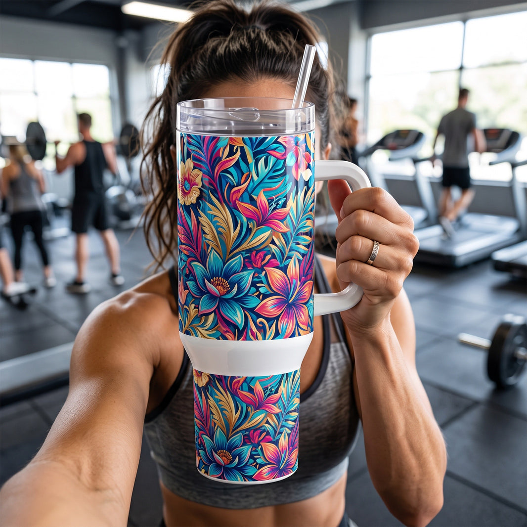 Bold floral full-wrap 40oz tumbler with handle held up at the gym