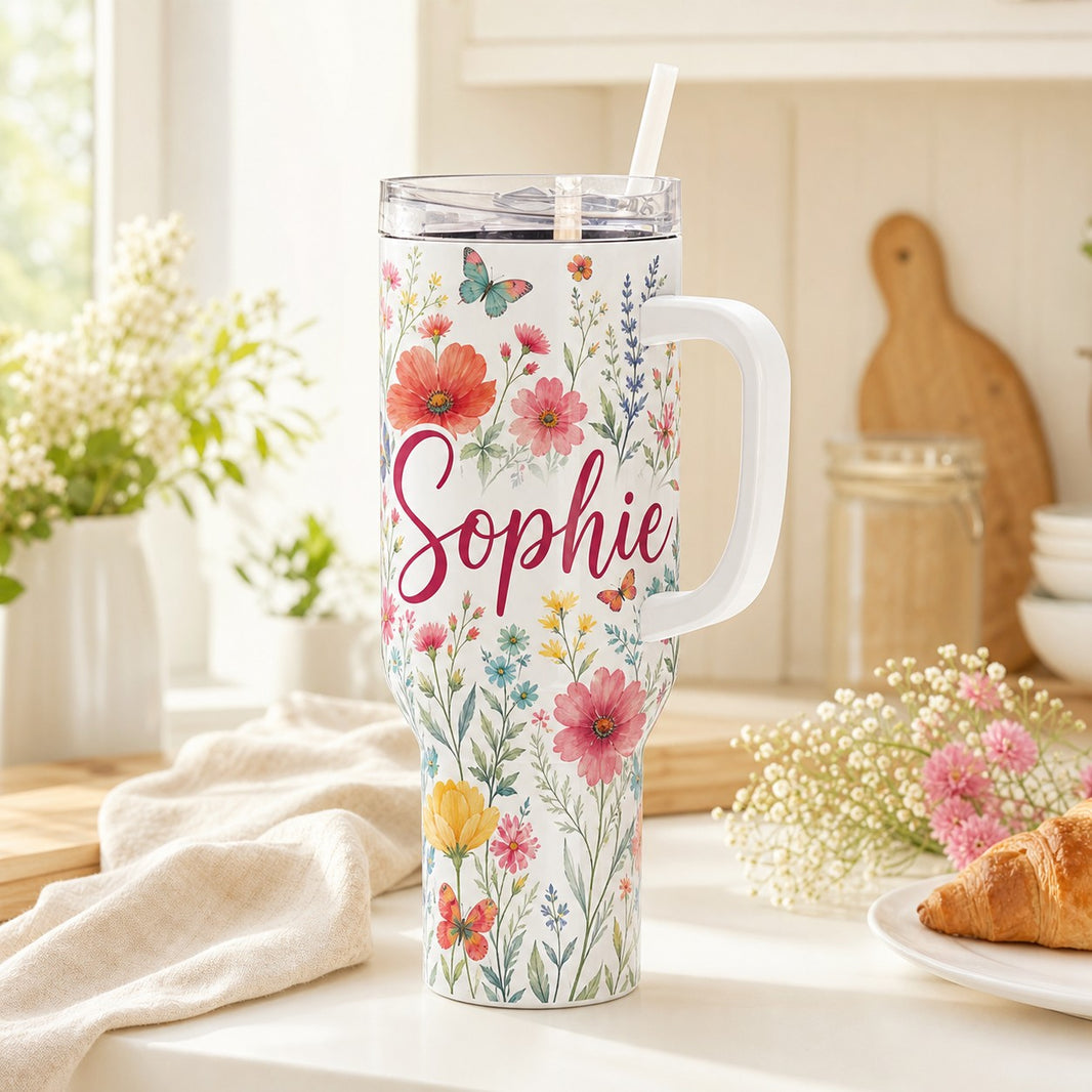 Personalised white 40oz tumbler with lid, straw and handle printed with wildflowers and the name Sophie on a kitchen counter
