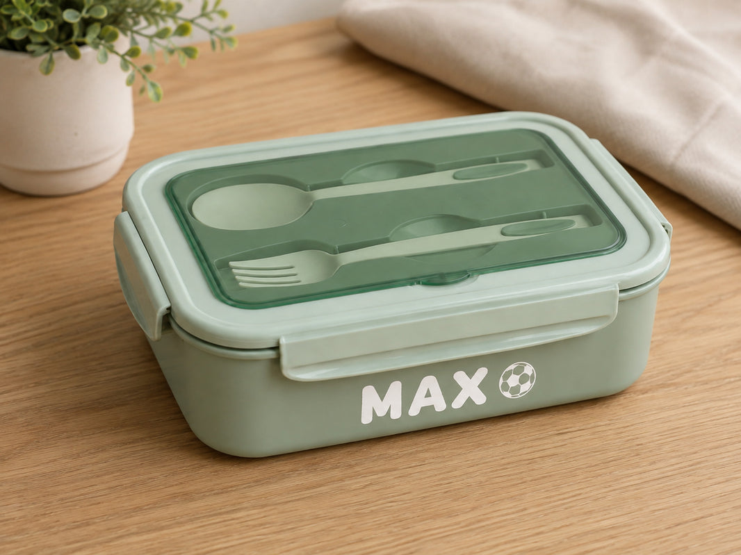 Green bento lunch box personalised with the name Max and a football icon in white vinyl