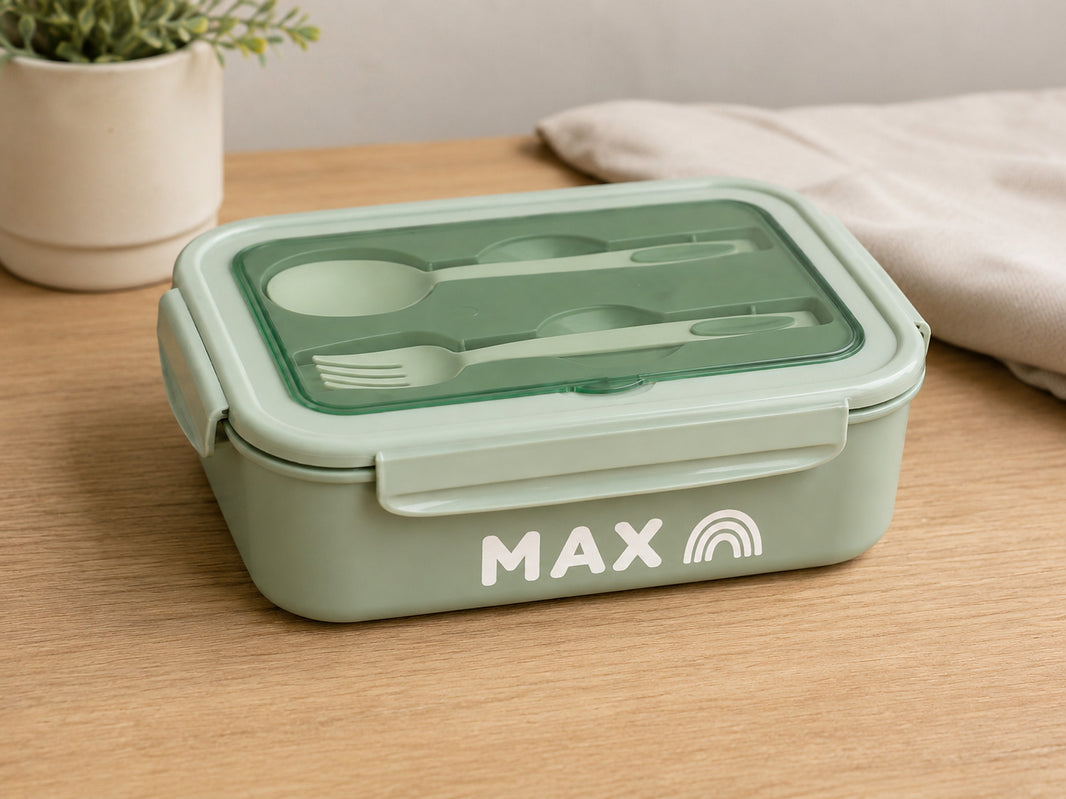 Green bento lunch box personalised with the name Max and a rainbow icon in white vinyl