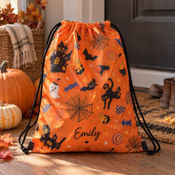 Personalised orange Halloween trick or treat bag with the name Emily, a drawstring bag printed with ghosts, bats and pumpkins