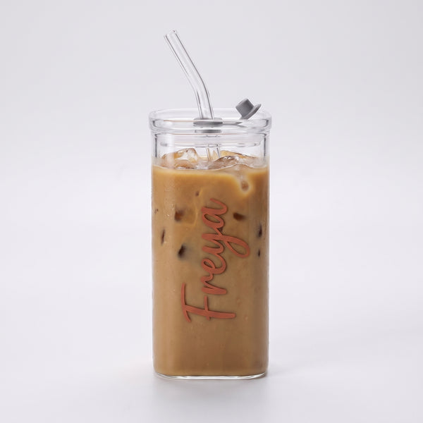Personalised iced coffee glass tumbler with a custom name, filled with iced coffee