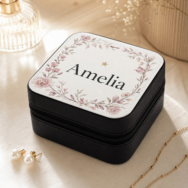 Personalised black travel jewellery box with floral wreath and the name Amelia printed on the lid, styled with pearl earrings