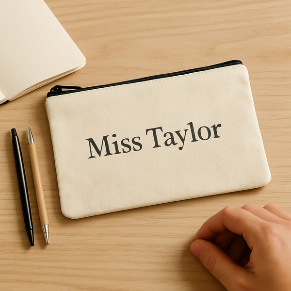 Personalised canvas pouch printed Miss Taylor on a desk — teacher gift