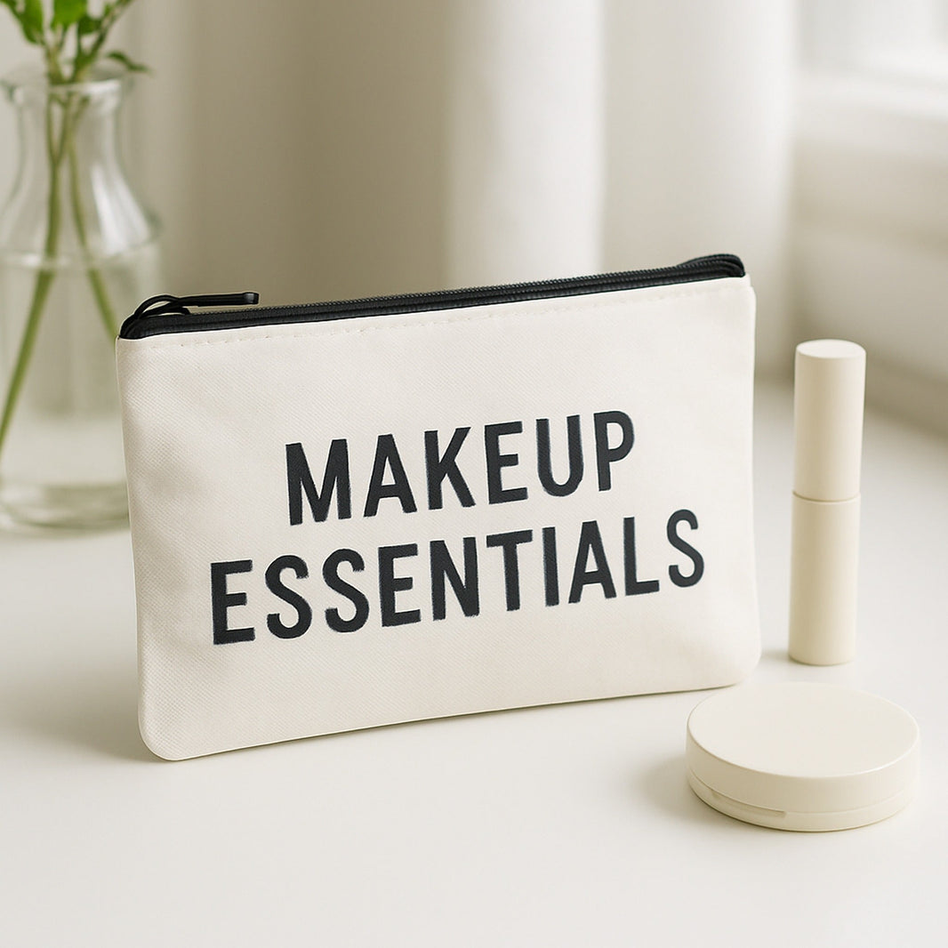 Cosmetic bag in white canvas with Makeup Essentials print on a bright dressing table