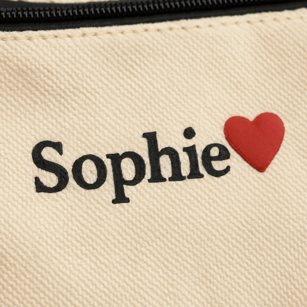 Pouch close-up of printed name and small red 3D puff icon on canvas