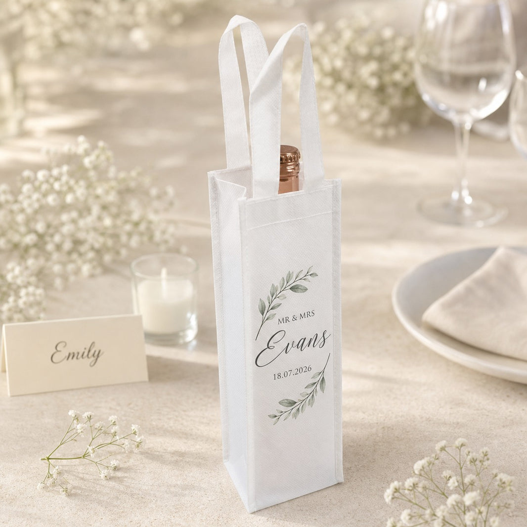Personalised Mr and Mrs mini wine bottle favour bag with surname and wedding date beside a place card