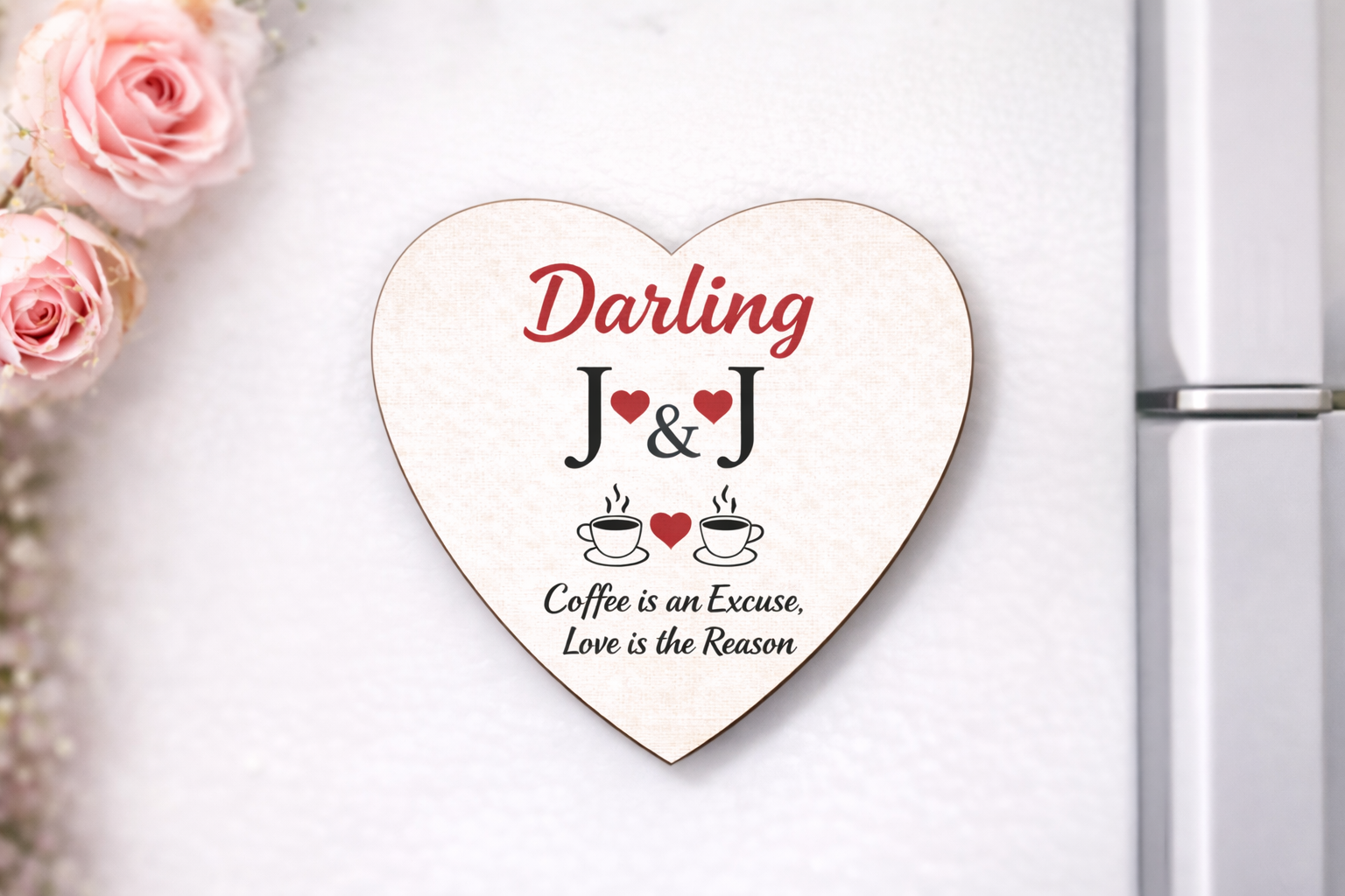 Heart-shaped wooden plaque with 'Darling J&J' and coffee-themed text on a white surface with pink roses.